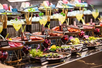 a buffet filled with food and glasses of champagne at Voya Beach Resort - Ultra All Inclusive in Sveti Vlas