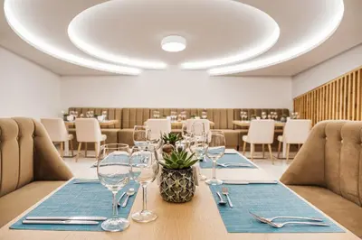 a dining room with a table with wine glasses at Voya Beach Resort - Ultra All Inclusive in Sveti Vlas