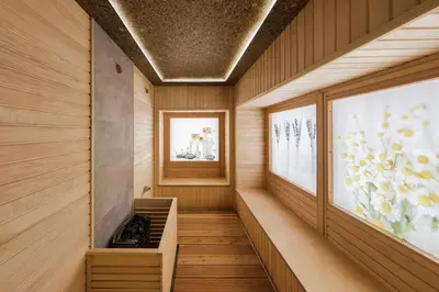 a sauna with wood paneling and a fireplace at Voya Beach Resort - Ultra All Inclusive in Sveti Vlas