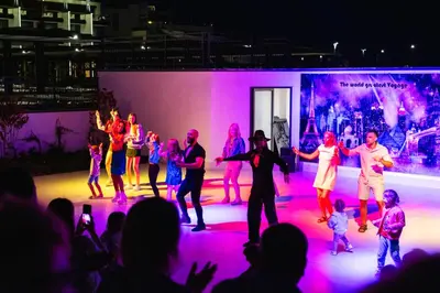 a group of people dancing on a stage at night at Voya Beach Resort - Ultra All Inclusive in Sveti Vlas