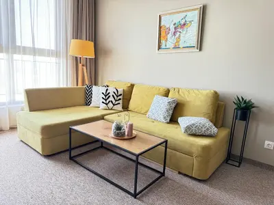 a living room with a couch and a coffee table at City view in Residences in Burgas City