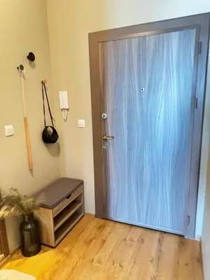a blue door in a room with a wooden floor at City view in Residences in Burgas City