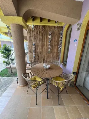 a table and chairs sitting on a patio at Къмпинг градина луксозен апартамент in Chernomorets
