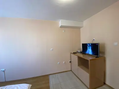 a room with a tv sitting on a dresser at MESSEMBRIA A309 Studio Sunny Beach in Sunny Beach