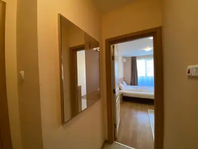 a hallway with a mirror and a room with a bed at MESSEMBRIA A309 Studio Sunny Beach in Sunny Beach