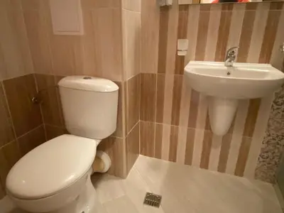 a bathroom with a toilet and a sink at MESSEMBRIA A309 Studio Sunny Beach in Sunny Beach