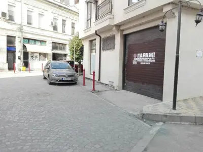 a car parked in a parking lot next to a building at Apartament deluxe Karina-Free parking in Burgas City