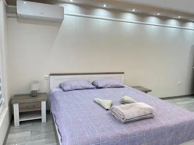 a bedroom with a bed with two pillows on it at Apartament deluxe Karina-Free parking in Burgas City