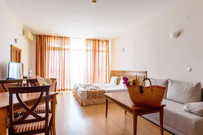 a living room with a couch and a table at Tiva del Mar Beach Hotel in Sveti Vlas