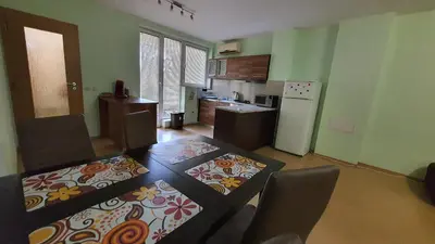a kitchen with a table and chairs and a kitchen with a tableablish at Minimalistic 1BR flat with a Parking spot in Varna City