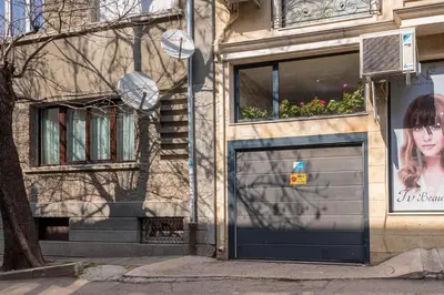 a building with a garage door with a girl on it at Minimalistic 1BR flat with a Parking spot in Varna City