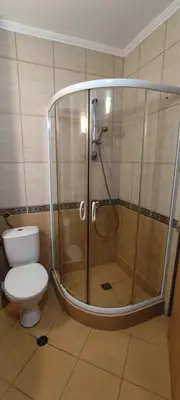a shower stall in a bathroom with a toilet at Central Plaza - Studio - Sunny Beach in Sunny Beach