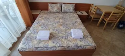 a bedroom with two beds and a table at Central Plaza - Studio - Sunny Beach in Sunny Beach