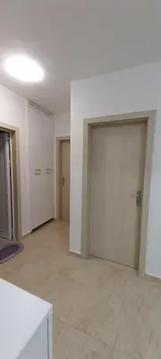 an empty room with two doors in a building at Sea Dreams Apartment in Sveti Vlas