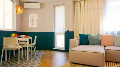 a living room with a couch and a table at Апартамент Жасмин с частен гараж - Jasmin Apartment with private garage in Varna City