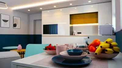 a kitchen with a table with bowls of fruit on it at Апартамент Жасмин с частен гараж - Jasmin Apartment with private garage in Varna City