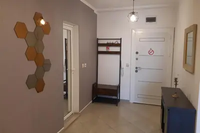 a room with a hallway with a door and a table at Апартамент Адикт in Sozopol
