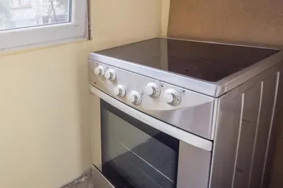 a stainless steel stove in a kitchen with a window at Best Price - Downtown Flat in Burgas City