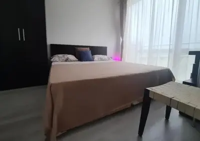 a bedroom with a large bed and a window at Atlantis Resort Sea View in Burgas City