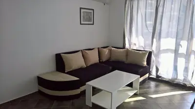 a living room with a couch and a table at Private apartment with sea view in Blue Bay Pallace in Pomorie