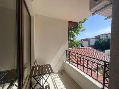 a balcony with a bench and a view at private apartments in Apolon in Ravda