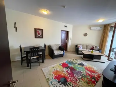 a living room with a couch and a table at private apartments in Apolon in Ravda