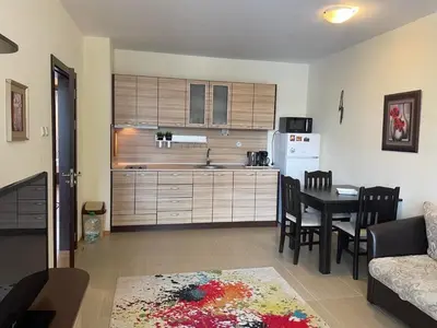 a living room with a kitchen and a dining room at private apartments in Apolon in Ravda