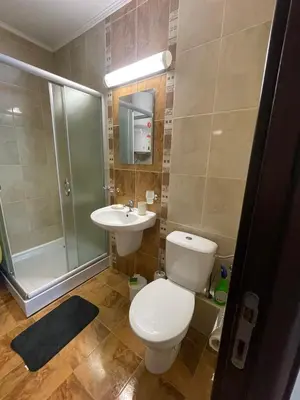 a bathroom with a toilet and a sink and a shower at private apartments in Apolon in Ravda