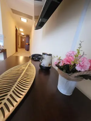 a wooden table with a vase of flowers on it at 