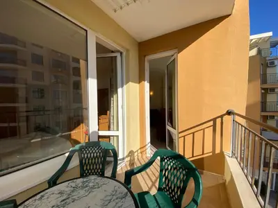 two green chairs sitting on a balcony at BLUE MARINE C16 Apartment Sunny Beach in Sunny Beach