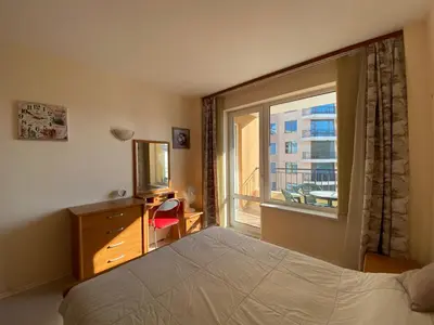 a bedroom with a bed and a large window at BLUE MARINE C16 Apartment Sunny Beach in Sunny Beach