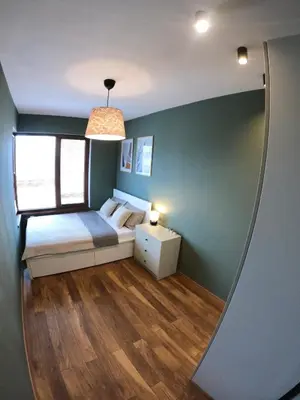 a small bedroom with a bed and a mirror at Dune Apartment Nessebar in Nesebar