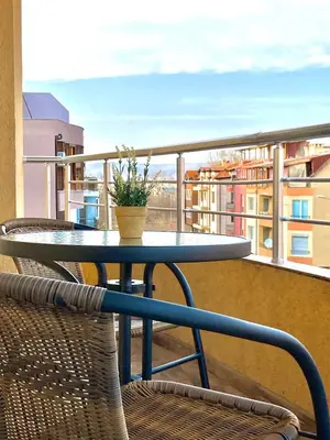 a table and chairs on a balcony with a view at Dune Apartment Nessebar in Nesebar