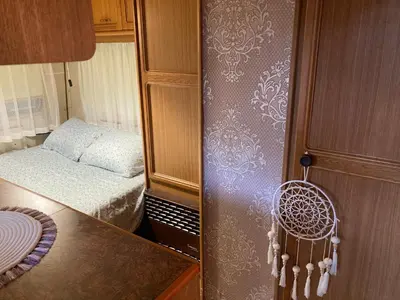 a small room with a small bed and a cabinet at Вила Елия - почивка край морето in Lozenets