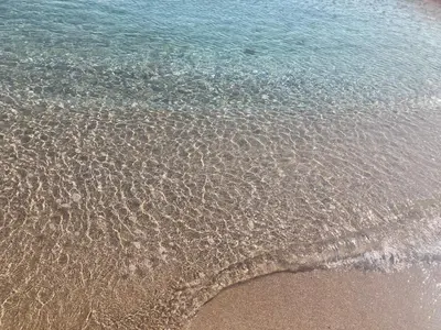 a close up of the sand and water on the beach at Вила Елия - почивка край морето in Lozenets