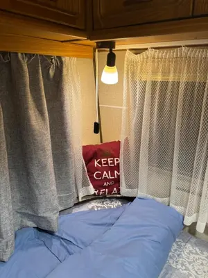 a bed with akeep calm sign in front of a window at Вила Елия - почивка край морето in Lozenets