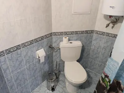 a bathroom with a toilet and a roll of toilet paper at Dean's Cozy 2 Bed Apart at Sunny Beach resort in Sunny Beach
