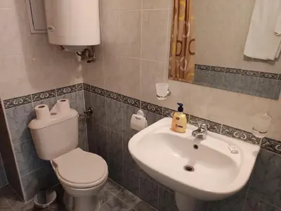 a bathroom with a toilet and a sink at Dean's Cozy 2 Bed Apart at Sunny Beach resort in Sunny Beach