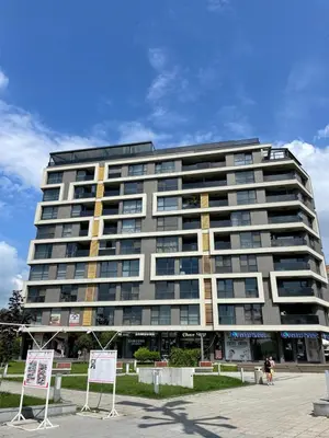 a large building with people walking in front of it at Felicity Super Central Apartment in Burgas City