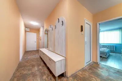 a bathroom with a wooden sink in a room at Daisy - 3 Room and kitchen apartment in Lazur in Burgas City
