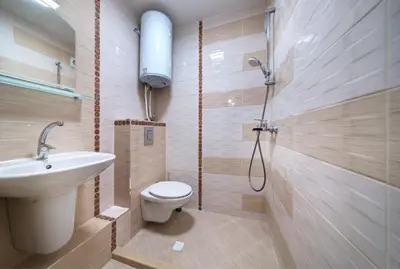 a bathroom with a toilet and a sink and a shower at Daisy - 3 Room and kitchen apartment in Lazur in Burgas City
