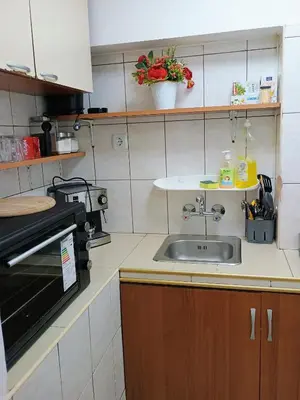 a kitchen with a sink and a microwave at Болярска10 in Burgas City