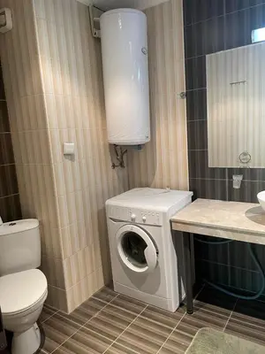 a bathroom with a washing machine and a toilet at Babylon SP apartment 56 in Sunny Beach