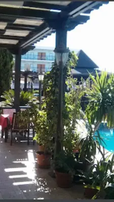 a patio with potted plants and a light pole at Babylon SP apartment 56 in Sunny Beach