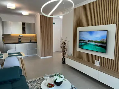 a living room with a tv on a wall at Luxury Private Apartment near Green Life Resort in Sozopol