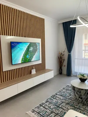 a living room with a flat screen tv on a wall at Luxury Private Apartment near Green Life Resort in Sozopol