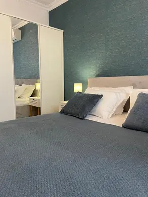 a bedroom with a large bed and a mirror at Luxury Private Apartment near Green Life Resort in Sozopol