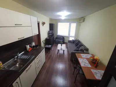 a kitchen and living room with a couch and a table at Двустаен апартамент в центъра на гр. Бургас in Burgas City