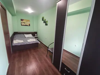 a small room with a bed and a mirror at Двустаен апартамент в центъра на гр. Бургас in Burgas City