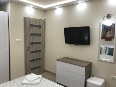 a room with a tv on a wall with a table at Sunrise Beach A4, Sarafovo in Burgas City